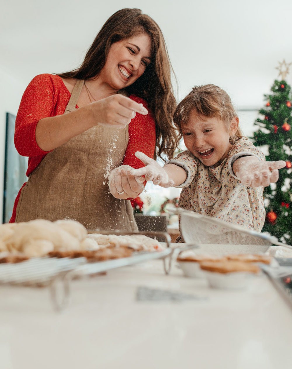 Mother and daughter having fun while making Christmas cookies.