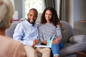 A Little Rock couples counseling therapist works with a smiling man and woman who are improving their marriage through couples counseling.